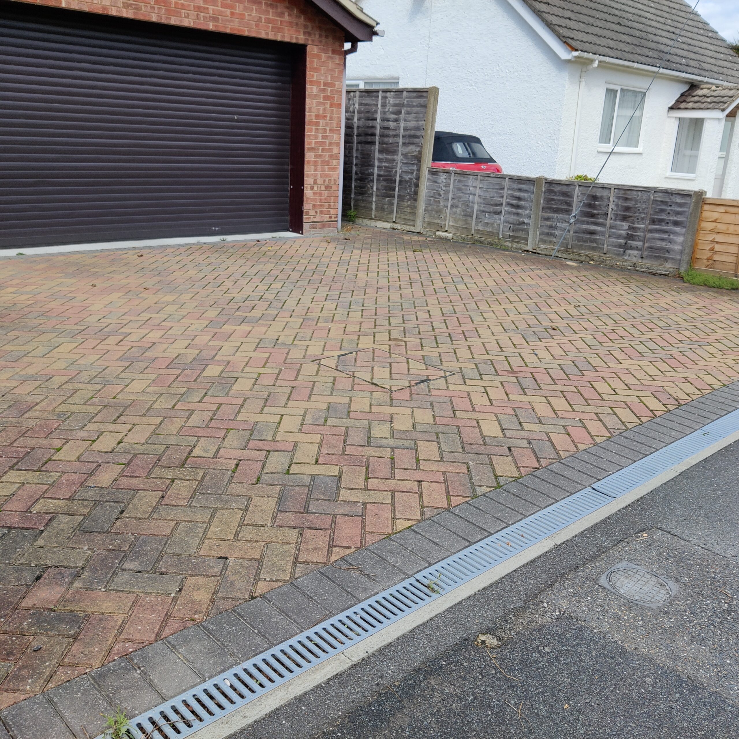 Block paving driveway laid in a herringbone pattern