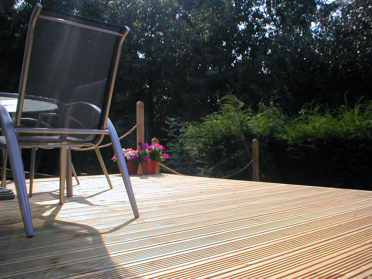 Raised timber deck levelled across a sloping garden in Bourne