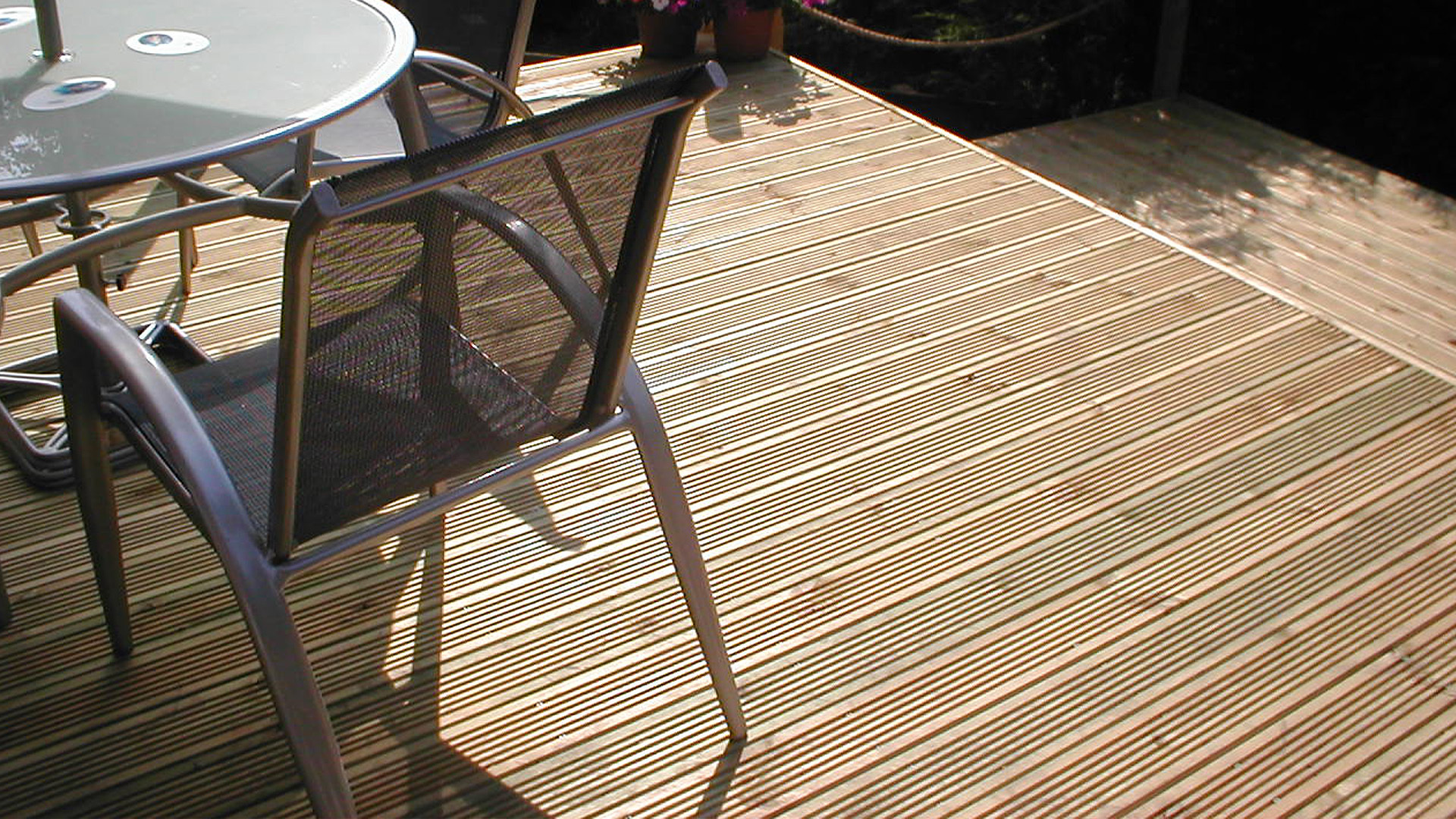 Close up of natural timber decking boards showing the grooved finish